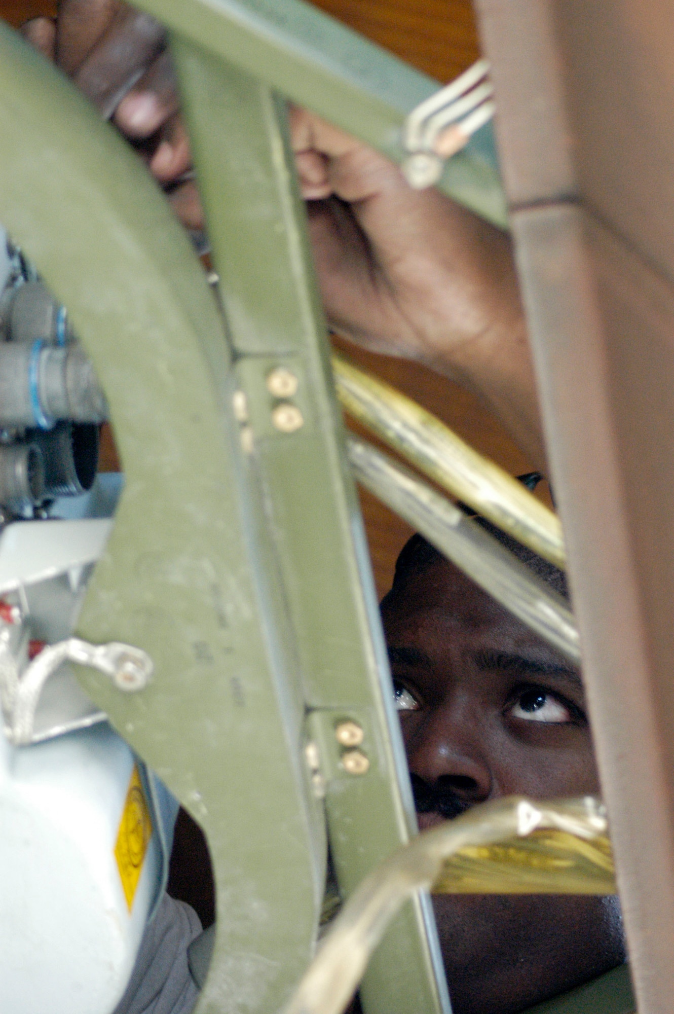 Staff Sgt. Alonzo Perry installs safety wire on an APN-59 radar transmitter and receiver-set in the nose of a C-130 Hercules Aug 28 at Bagram Airfield, Afghanistan.  Sergeant Perry is a communication and navigation system specialist from the 166th Airlift Wing, Delaware Air National Guard.  He is deployed to the 455th Expeditionary Maintenance Group at Bagram in support of Operation Enduring Freedom.  The radar antenna needed to be replaced and the safety wire prevents the fasteners from vibrating loose during flight.  (US Air Force photo/Maj. David Kurle)