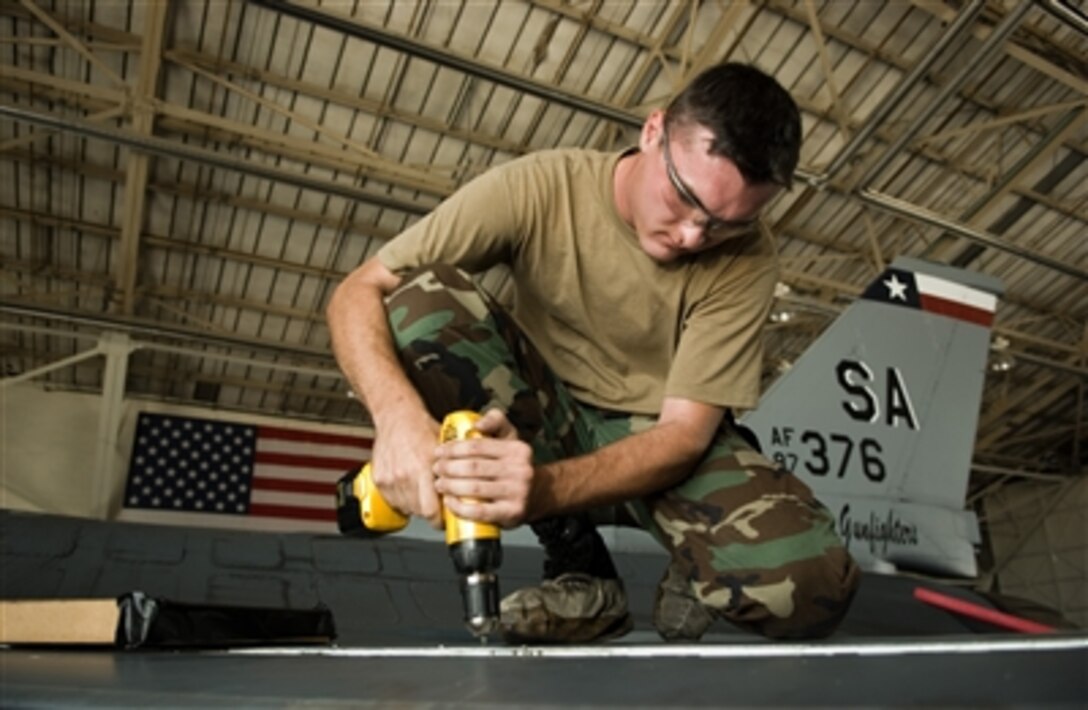 Air Force Senior Airman Chris Hamilton works on the right leading edge of the wing on an F-16 Fighting Falcon aircraft in a hangar at Lackland Air Force Base, Texas, on Aug. 24, 2006.  Hamilton is attached to the 149th Maintenance Squadron.  