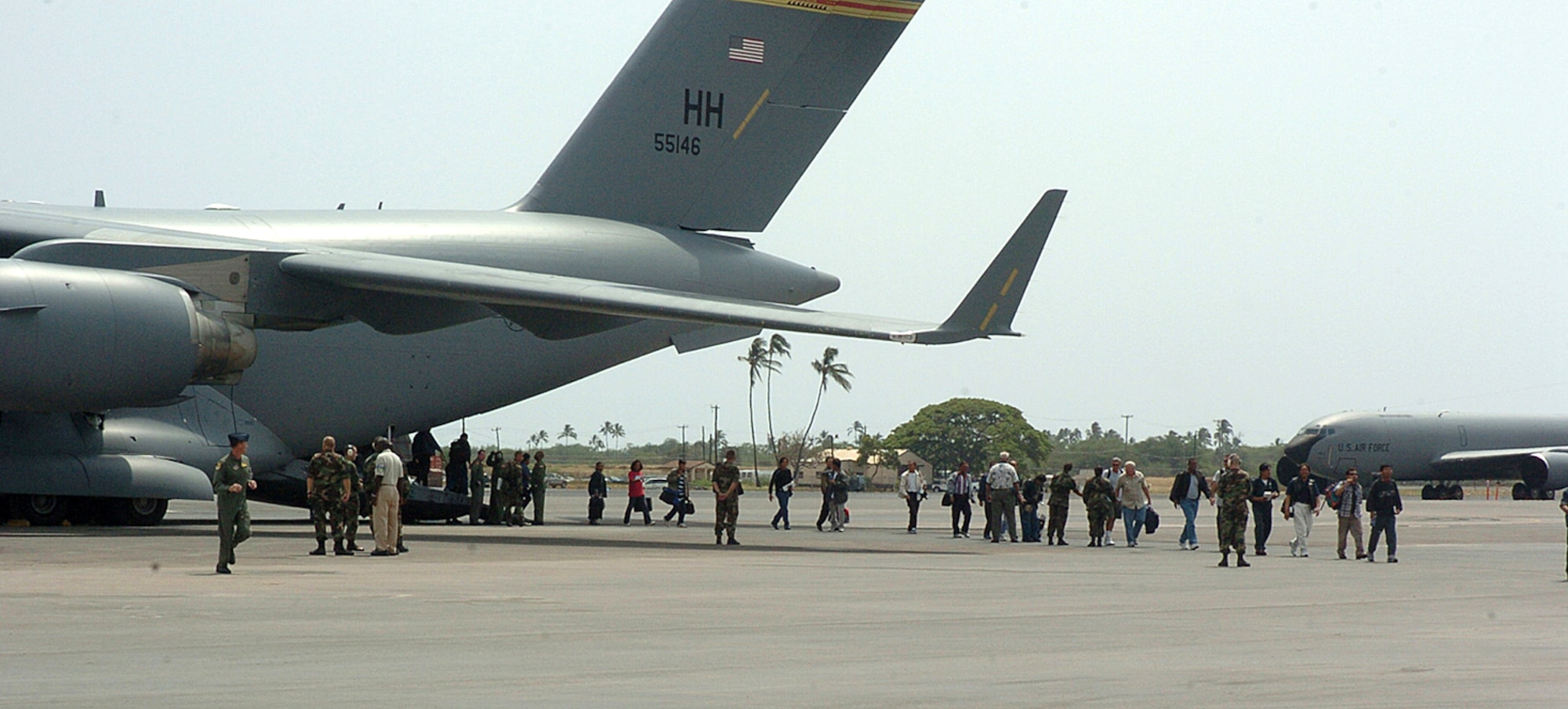 Wake Island evacuees exit a C-17 Globemaster III, at Hickam Air Force Base, Monday. The island's 188 people were evacuated prior to Super Typhoon Ioke reaching the tiny U.S. territory. Ioke is expected to hit the island around 8.p.m. EDT Wednesday. (U.S. Air Force photo/Tech. Sgt. Andrew Leonhard) 
