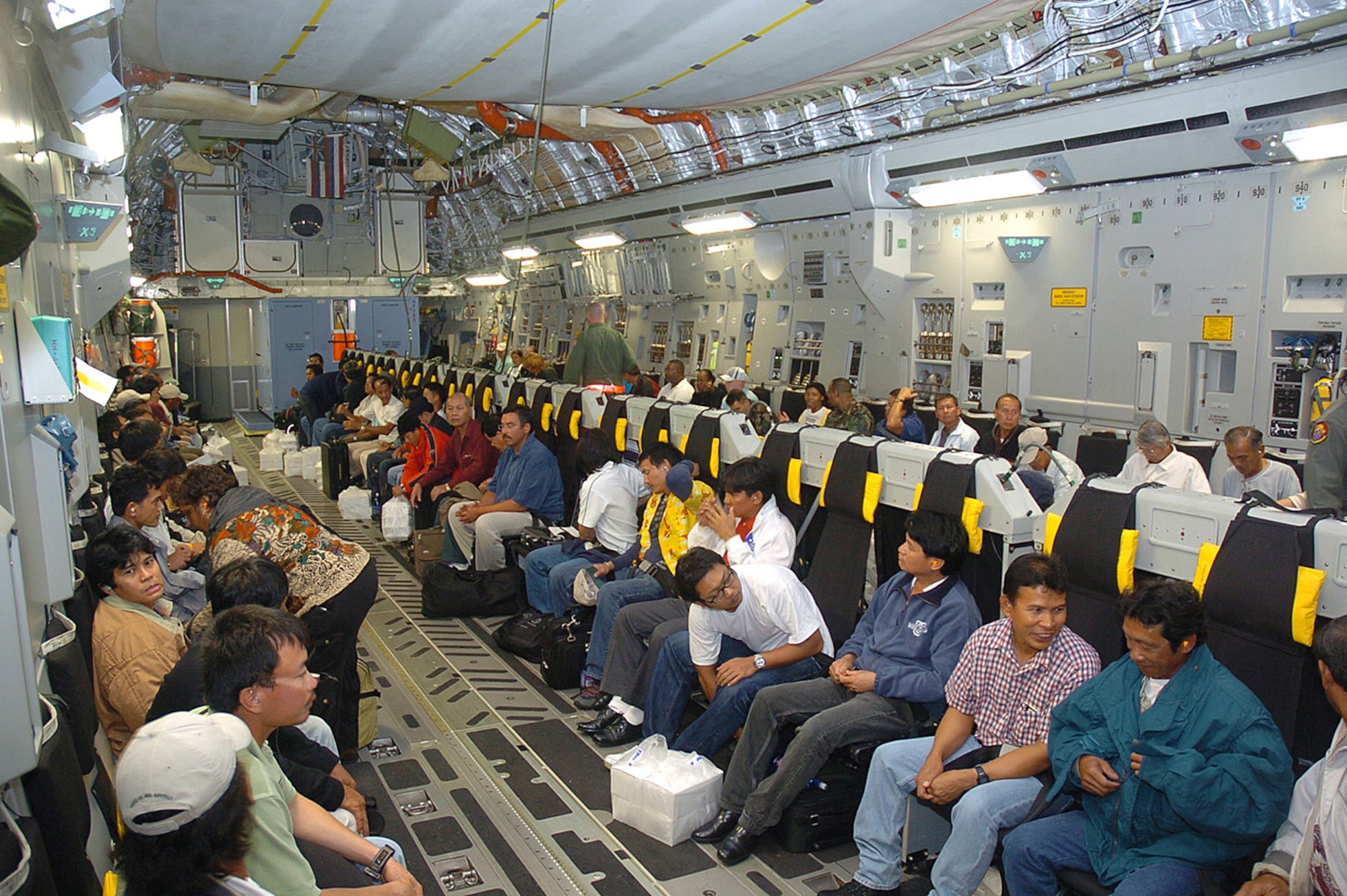 Some of the 188 Wake Island evacuees take their seats on a C-17 Globemaster III, from Hickam Air Force Base, Monday prior to Super Typhoon Ioke reaching the tiny U.S. territory. Ioke is expected to hit the island around 8.p.m. EDT Wednesday. (U.S. Air Force photo/Tech. Sgt. Andrew Leonhard)
