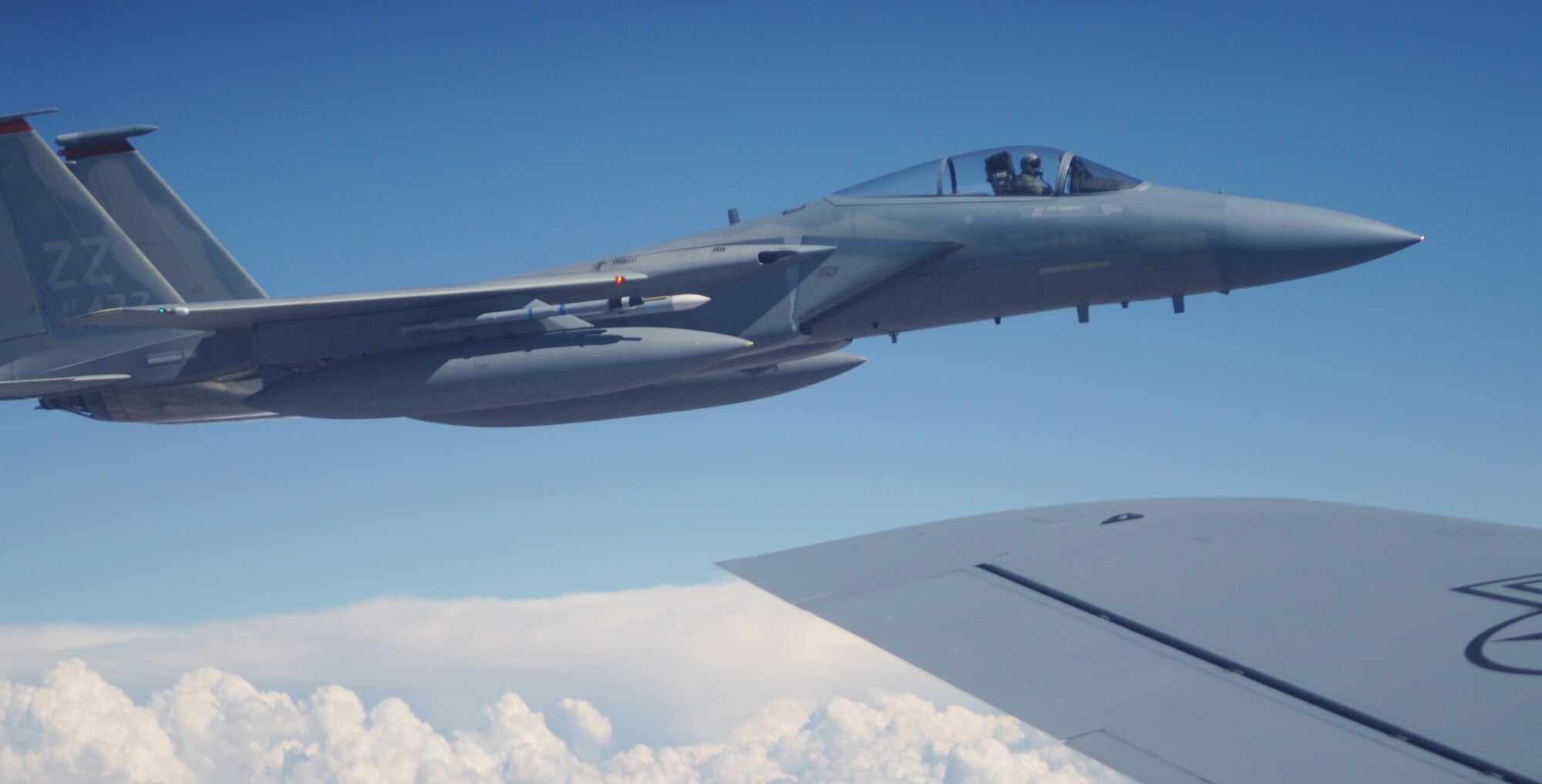 NELLIS AFB, Nev. -- An F-15 Eagle from Kadena Air Base, Japan, flies formation with a KC-135 while others in the flight refuel. The F-15s are taking part in Red Flag, a large-force exercise taking place over the 15,000-square-mile Nevada Test and Training Range. The exercise ends Sept. 2. (U.S. Air Force photo/Senior Airman Travis Edwards)