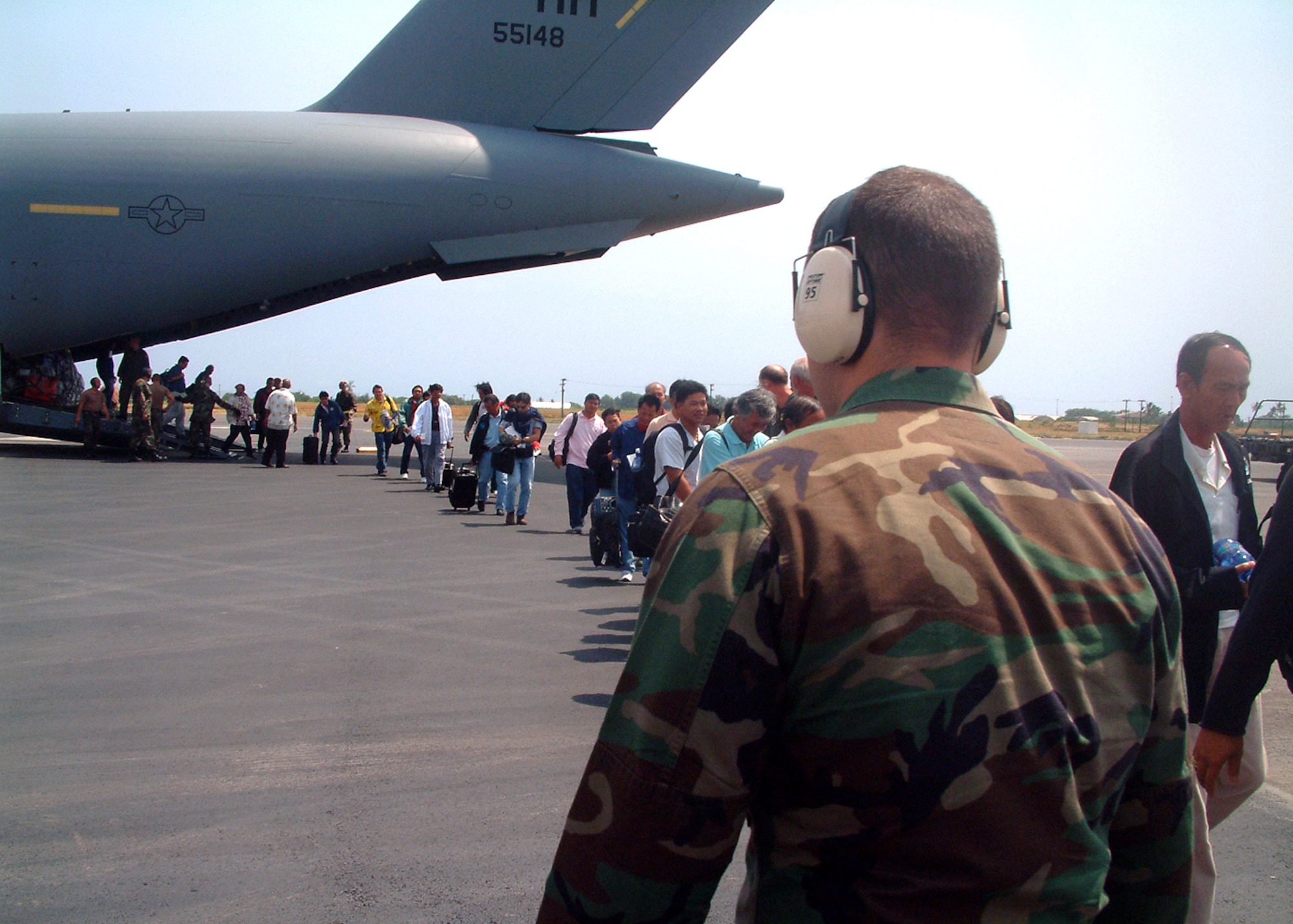 Evacuees from Wake Island arrive at Hickam Air Force Base, Hawaii, Aug. 28. Two C-17 Globemaster IIIs from the 15th Airlift Wing evacuated 188 people from the atoll in advance of Super Typhoon Ioke, which is forecast to hit Aug. 30. The 735th Air Mobility Squadron received and processed the evacuees through customs and immigration before they went to area hotels. (U.S. Air Force photo)

