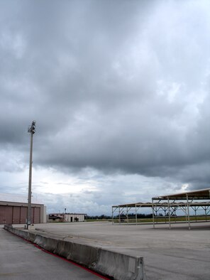 A normally bustling area, the aircraft parking ramp and maintenance facilities at Homestead Air Reserve Base, Fla., sit barren Aug. 29 as Tropical Storm Ernesto heads toward Florida. Pilots evacuated six F-16 Fighting Falcons to Naval Air Station Joint Reserve Base in Fort Worth, Texas, while another eight jets are at Hill Air Force Base, Utah. (U.S. Air Force photo/Dan Galindo)
