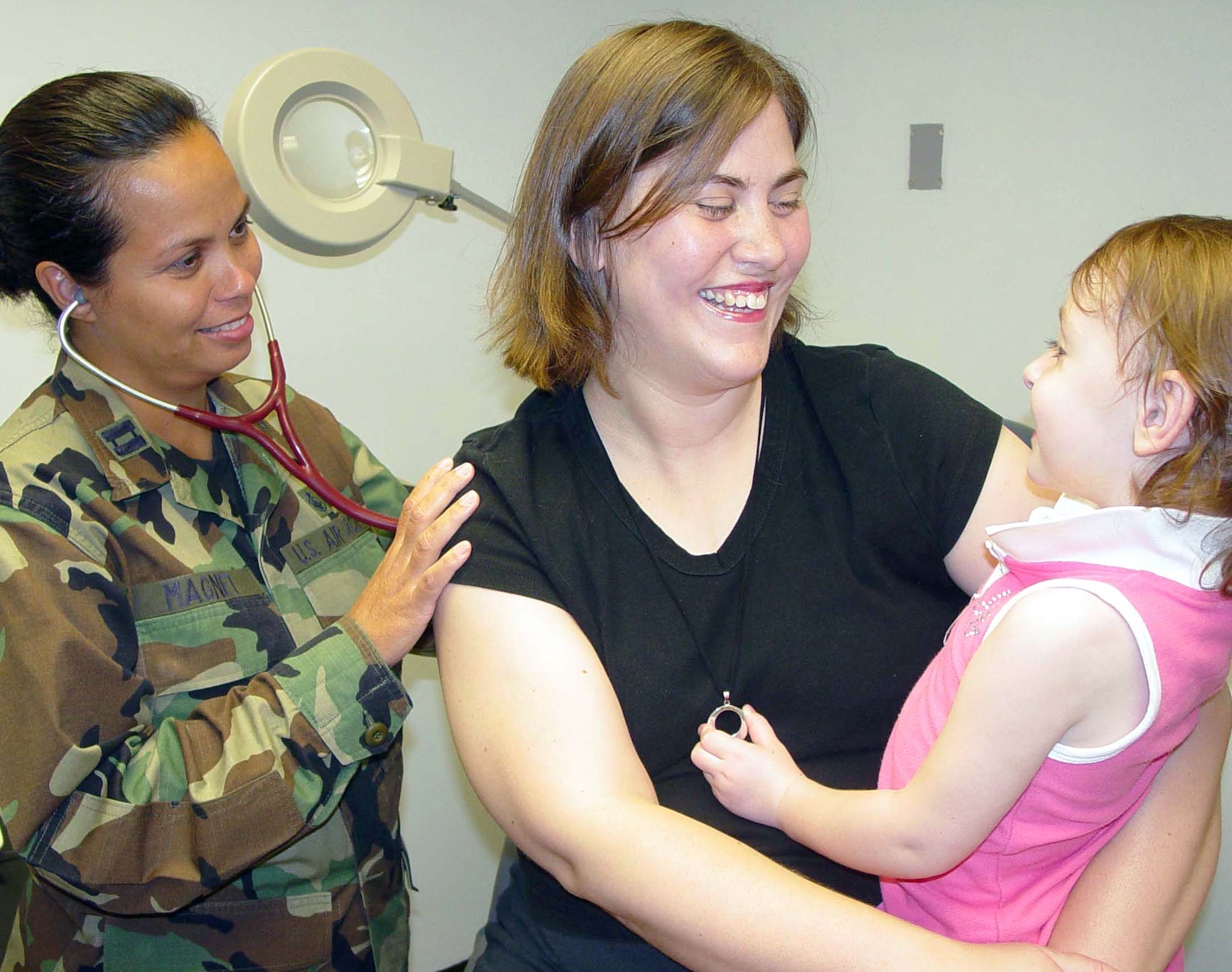 Capt. Marli Magnet examines Rebecka Rogers, holding daughter Alyssa, 3, during an appointment in the family practice clinic. Captain Magnet is a family practice nurse practioner for the 81st Medical Operations Squadron. Rebecka's husband, Senior Airman Christopher Rogers, is assigned to the 338th Training Squadron. Family practice, pediatric and women's health are scheduled to return to their pre-Katrina basement location in September. (U.S. Air Force photo/Steve Pivnick)