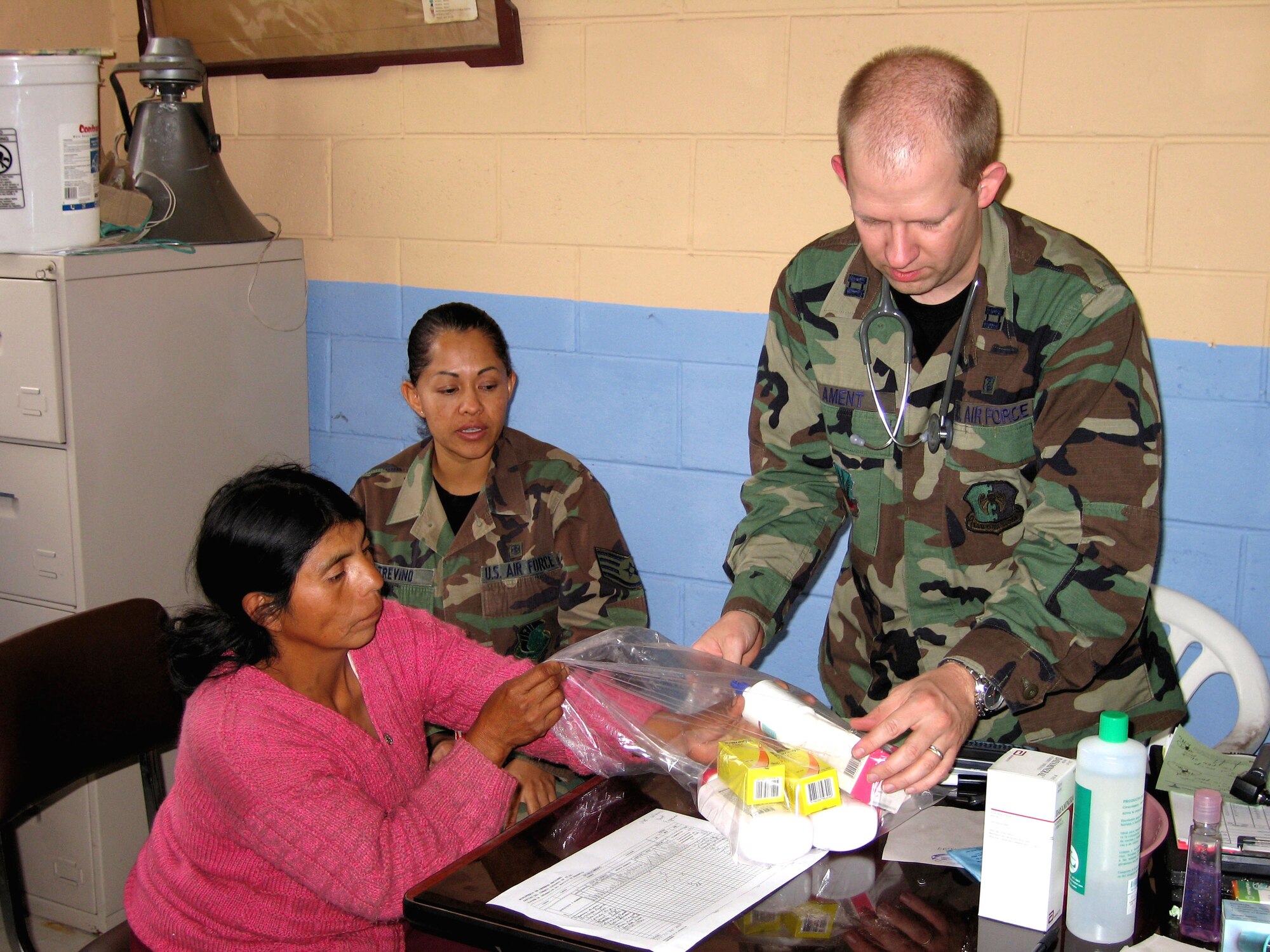 Capt. (Dr.) Aaron Ament (right) and Staff Sgt. Leticia Trevino provide medication to a patient in Pinepe, Ecuador, for symptoms caused by the Tungurahua volcano eruption Aug. 16. Captain Ament is a family practice physician from Minot Air Force Base, N.D. Sergeant Trevino is a translator and lab technician from Lackland AFB, Texas. (U.S. Air Force photo/Capt. Nancy Kuck)