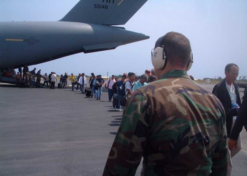 HICKAM AIR FORCE BASE, Hawaii -- Evacuees from Wake Island arrive at Hickam Air Force Base, Aug. 28. Two C-17s from the 15th Airlift Wing evacuated all 188 people from the atoll in advance of Super Typhoon Ioke which is forecasted to hit Aug. 30. The 735th Air Mobility Squadron received and processed the evacuees through customs and immigration before they went to area hotels. (U.S. Air Force photo)