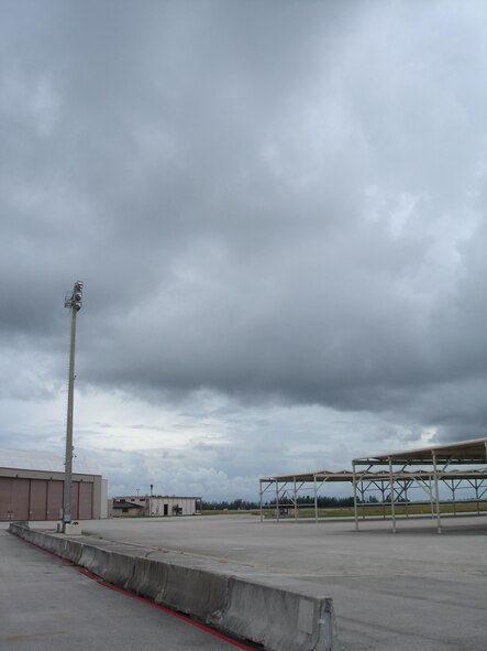 A normally bustling area, the aircraft parking ramp and maintenance facilities here at Homestead Air Reserve Base, Fla. sit barren Aug. 29 as Tropical Storm Ernesto heads toward Florida. Pilots evacuated six F-16s to Naval Air Station Joint Reserve Base, Ft. Worth, Texas, while another eight jets are at Hill Air Force Base, Utah. (US Air Force photo by Dan Galindo)