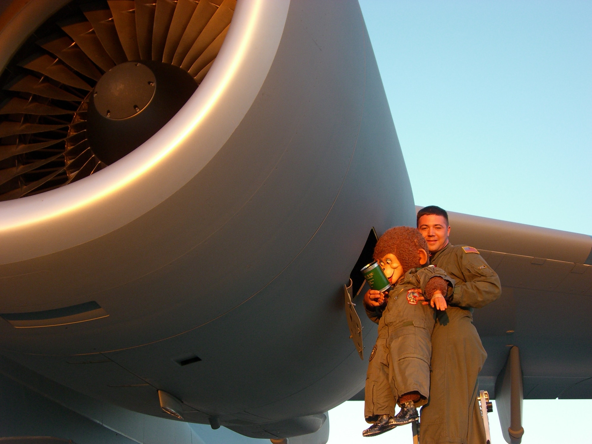 Lieutenant Howard, being held by Tech. Sgt. John Carter, 860th Aircraft Maintenance Squadron, ensures the engines on the “Spirit of Solano” have enough oil before its first mission at Travis Air Force Base Aug. 9. (U.S. Air Force photo/Maj. Dennis Wolf)
