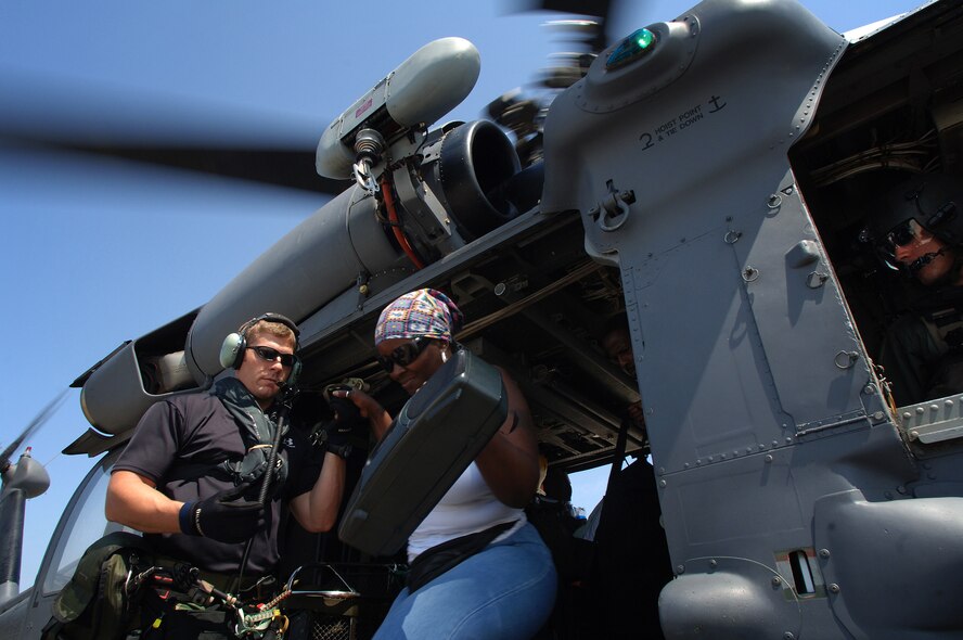 Air Force rescue crews help move evacuees from temporary collection points to the New Orleans's airport where they are processed and moved to more permanent accommodations.  (U.S. Air Force photo by Master Sgt. Efrain Gonzalez)