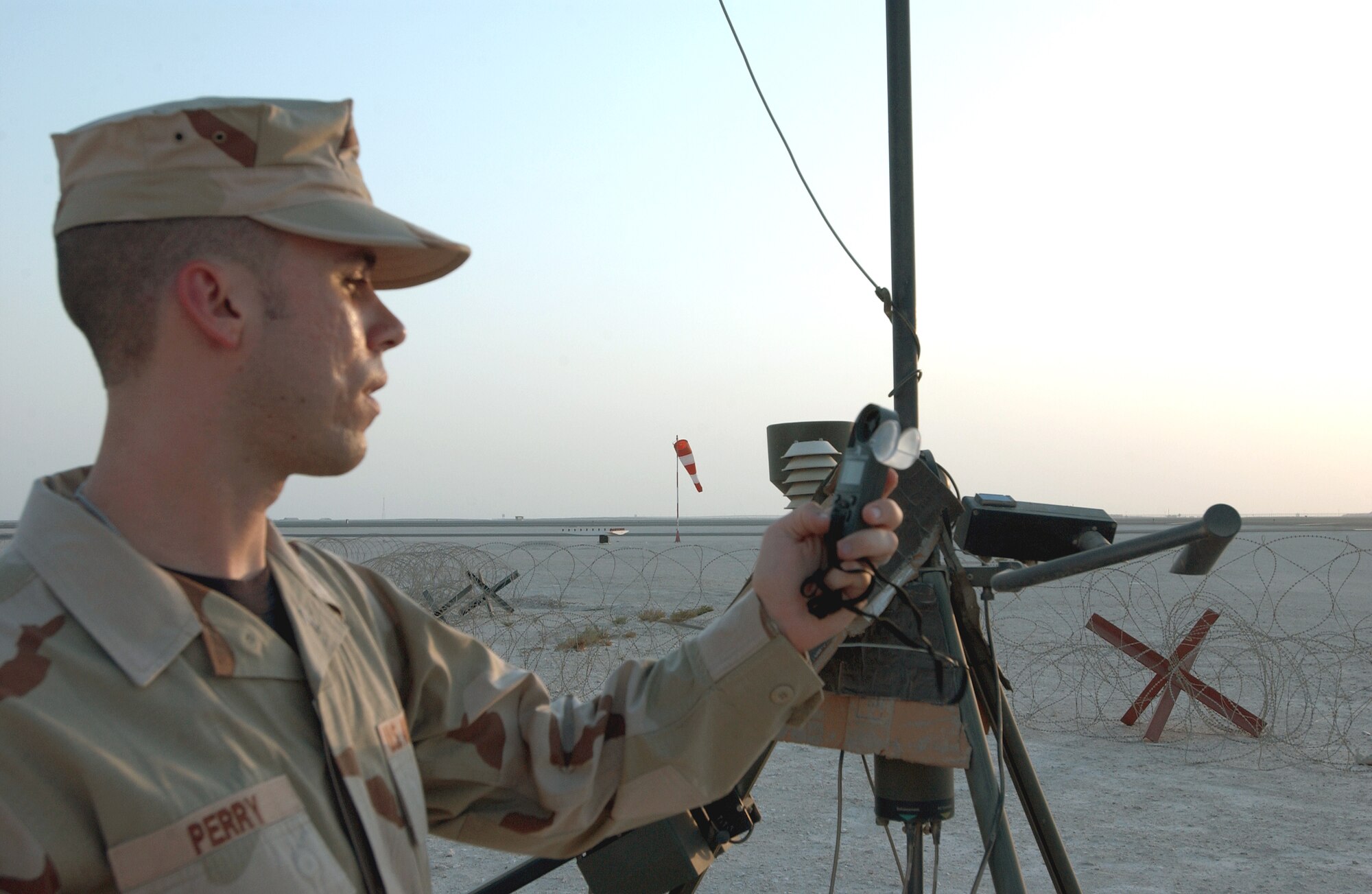 Senior Airman Daniel Perry takes a wind reading at a forward operating base in Southwest Asia Aug. 25. Airman Perry is a weather forecaster assigned to the 379th Expeditionary Operations Support Squadron and is deployed from Robins Air Force Base, Ga. (U.S. Air Force photo/Master Sgt. John DeGroot) 
