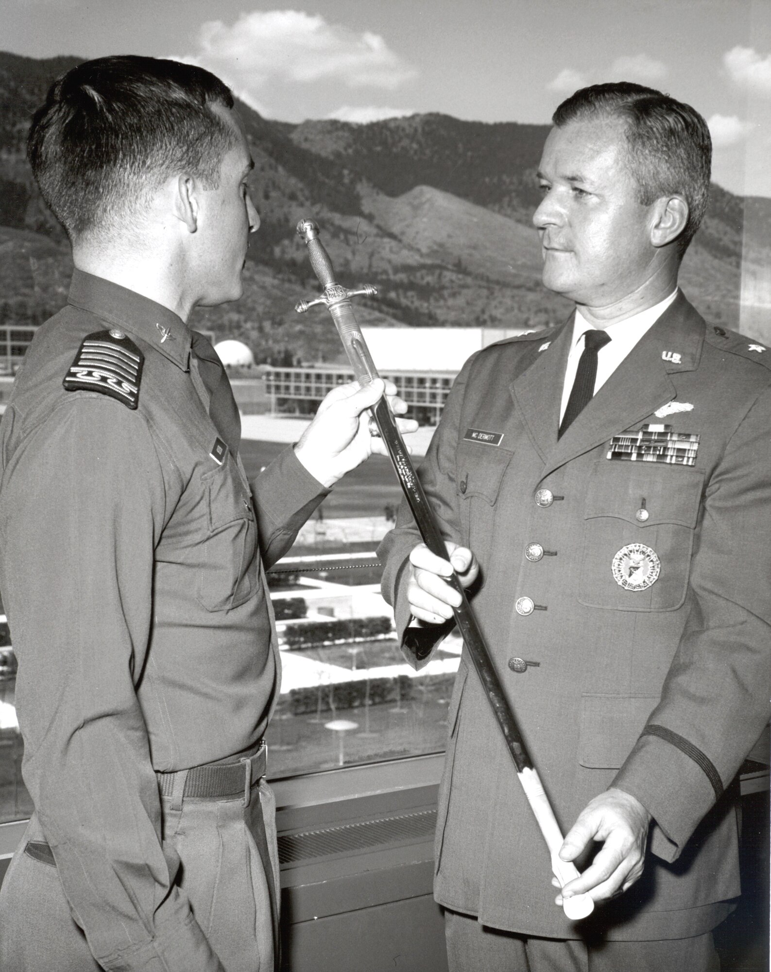 Brig. Gen. Robert F. McDermott receives an inscribed cadet saber from Cadet Wing Commander Jerrold Allen, April 28, 1966, in recognition of his pioneering innovations in the field of service academy education. (U.S. Air Force photo) 
