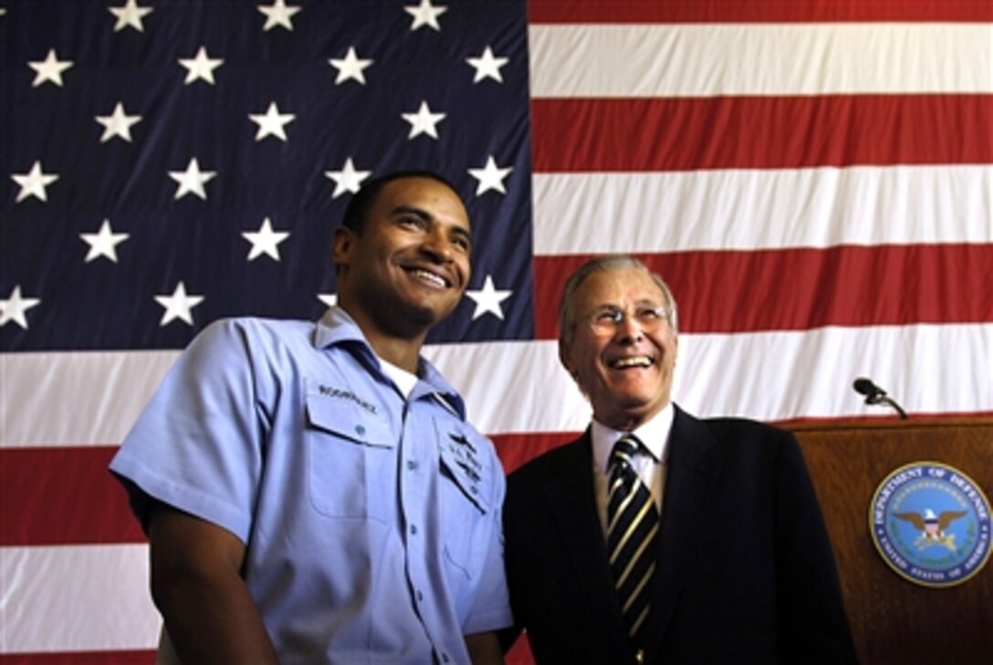 U.S. Defense Secretary Donald H. Rumsfeld takes a picture with a sailor at the conclusion of a town hall meeting at Fallon Naval Air Station, Nev., Aug. 28, 2006. Rumsfeld answered questions that ranged from health care to the global war on terrorism. 