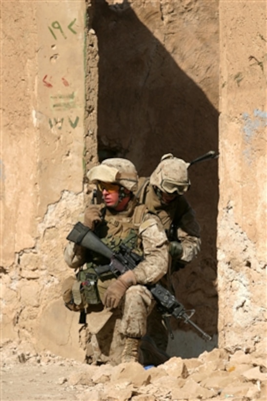 U.S. Marine Corps Sgt. Mike B. Dunn takes cover in an abandoned house after being fired upon during a patrol through Haditha, Iraq, on Aug. 11, 2006.  Dunn is attached to India Company, 3rd Battalion, 3rd Marine Regiment, Regimental Combat Team 7, I Marine Expeditionary Force (Forward).  