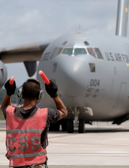 Airman 1st Class Nelson Good marshals out a C-17 Globemaster III Aug. 30 from Charleston Air Force Base, S.C. Airmen from Charleston AFB are in the process of evacuating all operational C-17 aircraft on station due to impending severe weather expected from Tropical Storm Ernesto. Airman Good is from the 437th Aircraft Maintenance Squadron. (U.S. Air Force photo/Airman 1st Class Nicholas Pilch) 