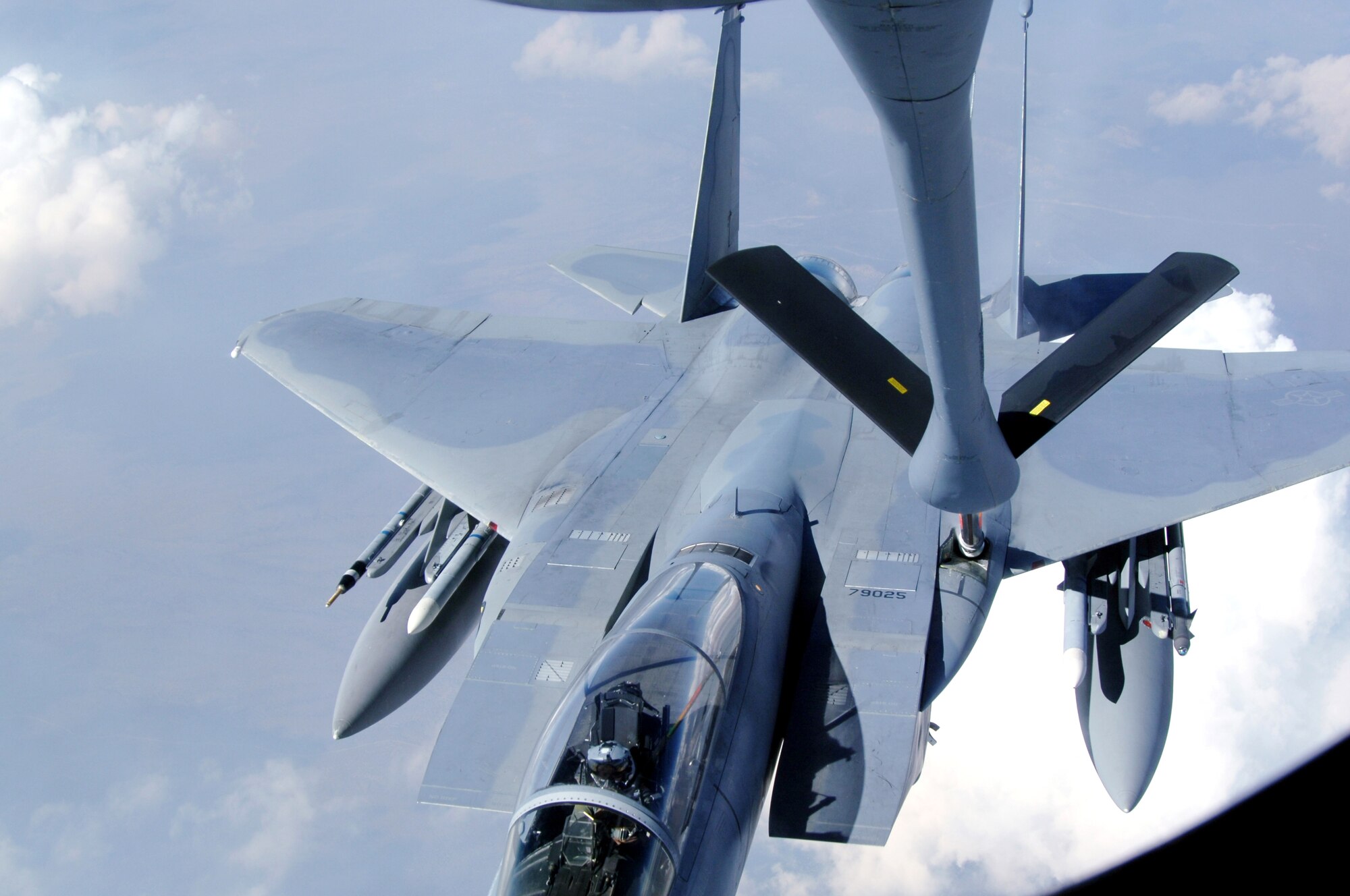 An F-15 Eagle from Kadena Air Base, Japan, pulls away from a KC-135 Stratotanker after refueling during Red Flag, a two-week exercise that tests and trains servicemembers in real-time combat situations at Nellis Air Force Base, Nev. Red Flag is conducted over the Nevada Test and Training Range, which has more than 2.9 million acres of airspace. The KC-135 is based at MacDill AFB, Fla. (U.S. Air Force photo/Senior Airman Travis Edwards) 