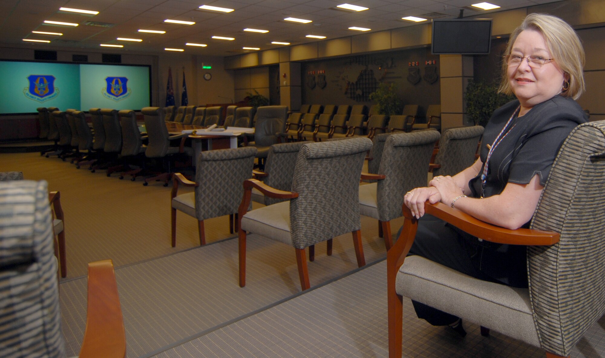 Pat McCutchin sits inside the Headquarters Air Force Reserve Command conference center at Robins Air Force Base, Ga. As the command's senior interior designer, Ms. McCutchin has overseen the comprehensive interior design on hundreds of new AFRC construction and renovation projects, including the conference center. (U.S. Air Force photo by Master Sgt. Chance C. Babin)