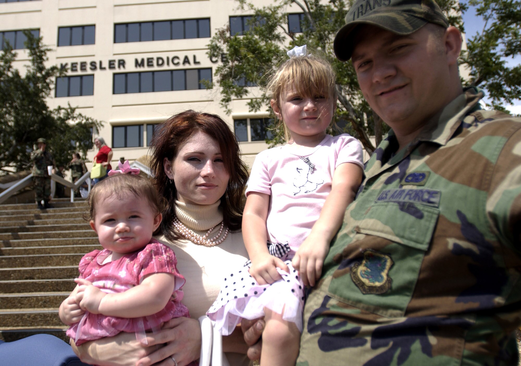 Sage Madison Post was born at the Keesler Air Force Base, Miss., medical center Aug. 29, 2005, under the illumination of flashlights because of Hurricane Katrina. Celebrating her first birthday at the medical center's official re-opening ceremony are her mother, Stephanie; sister, Austin; and father, Senior Airman Aaron Post. (U.S. Air Force photo/Tech. Sgt. Cecilio Ricardo Jr.)

