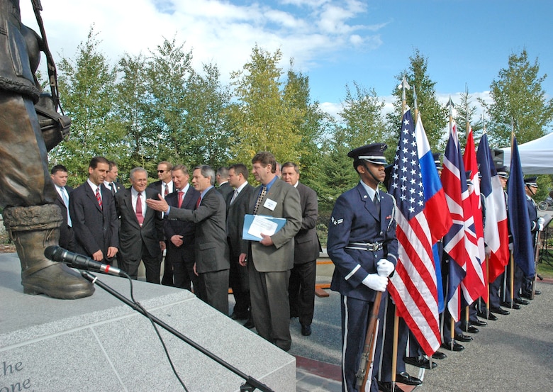 Former Alaska Senator John Binkley gives Secretary of Defense Donald Rumsfeld and Russian Minister of Defense Sergei Ivanov a tour of the $600,000 bronze and granite monument at the dedication of the Alaska-Siberia Lend-Lease Memorial in Fairbanks, Alaska, Aug. 27. The sculptures reflect the equipment and clothing pilots wore in the 1940s while stationed at Ladd Field in Fairbanks, now Fort Wainwright. At right is the Eielson Air Force Base honor guard. (U.S. Air Force photo/Senior Airman Justin Weaver) 