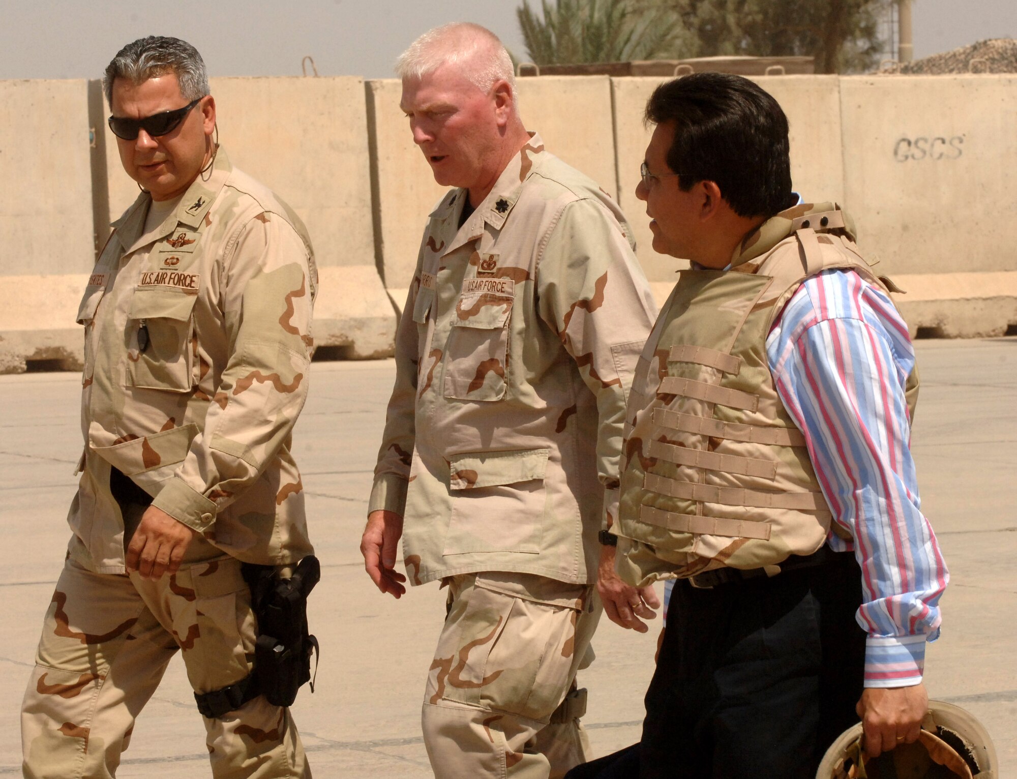 U.S. Attorney General Alberto Gonzales walks with Col. Abel Barrientes, the chief coalition military adviser at the Iraqi New Al Muthana Air Base, and Lt. Col. John Morris, 447th Air Expeditionary Group deputy commander, Aug. 29, during the U.S. Justice Department chief's tour. (U.S. Air Force photo/Staff Sgt. Bryan Bouchard)