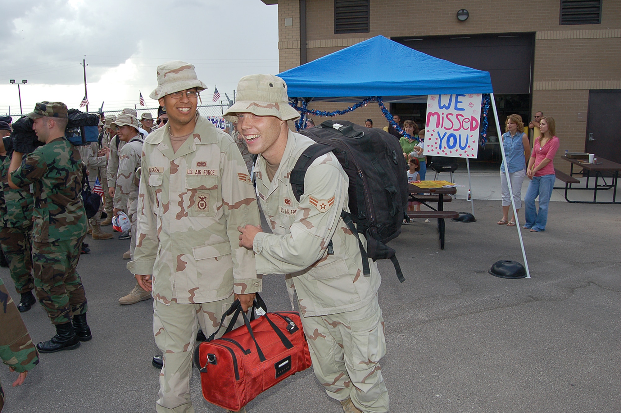 Airmen rush to meet friends and family after arriving at the 47th Security Forces Squadron at Laughlin Air Force Base, Texas Aug. 29, after serving a nine-month deployment in support of Operation Iraqi Freedom. (U.S. Air Force photo/Staff Sgt. Shad Eidson)