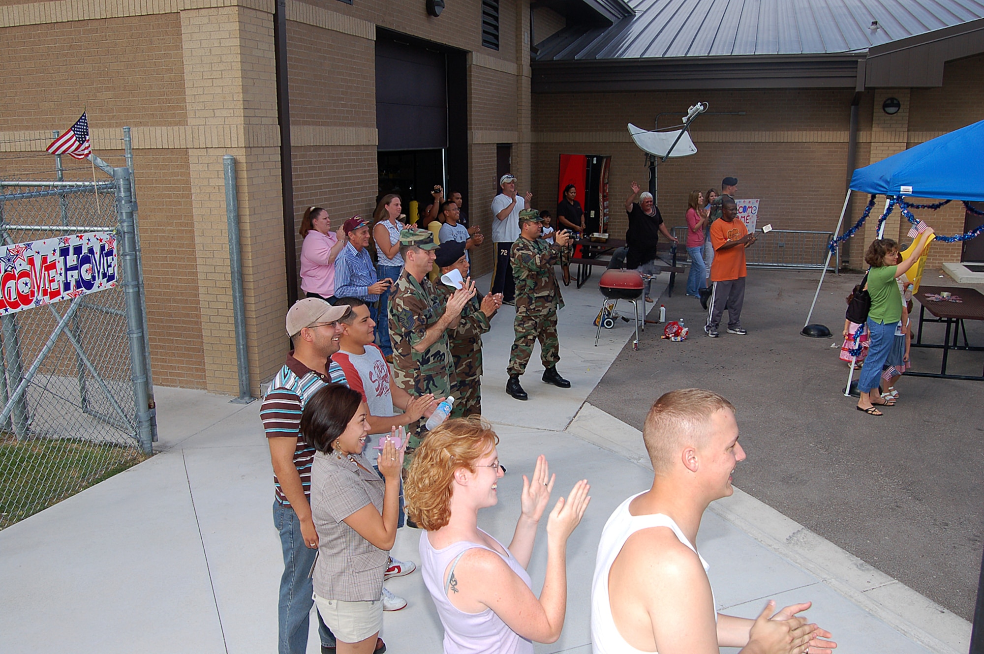 Friends, family and 47th Security Forces Squadron members cheer at the arrival of 13 Airmen returning to Laughlin Air Force Base, Texas Aug. 29 after a nine-month deployment in support of Operation Iraqi Freedom. (U.S. Air Force photo/Staff Sgt. Shad Eidson)