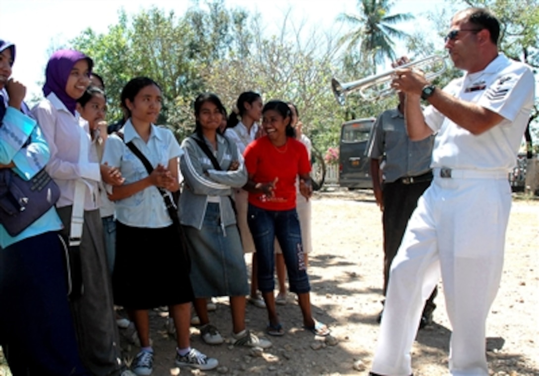 U.S. Navy Petty Officer 1st Class Brian Grondell plays a trumpet solo during a performance at Undana University in Kupang, Indonesia, Aug. 22, 2006. Grondell is a member of the U.S. Navy Showband currently deployed with the hospital ship USNS Mercy which is conducting humanitarian and civic assistance missions during its five-month deployment to South Asia, Southeast Asia and the Pacific Islands. 