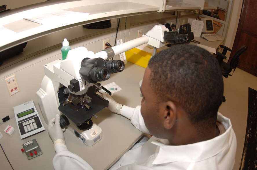 Airman Grand examines a stained blood sample Aug. 25 to determine the cause of an elevated white blood cell count, a standard procedure for lab techs.