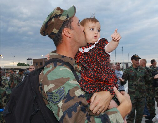 Whiteman Air Force Base, MO - Staff Sergeant Christopher Carpenter, 509th Bomb Wing, 509th Communications Squadron holds his 1 ½ year old daughter Cheyenne upon his return from Andersen AFB, Guam on 29 August 2006.  Members of the 509th Bomb Wing deployed for 120 days in support of Operation Ocean Fury.  (US Air Force photo by TSgt Joan D. Anderson-Brown)