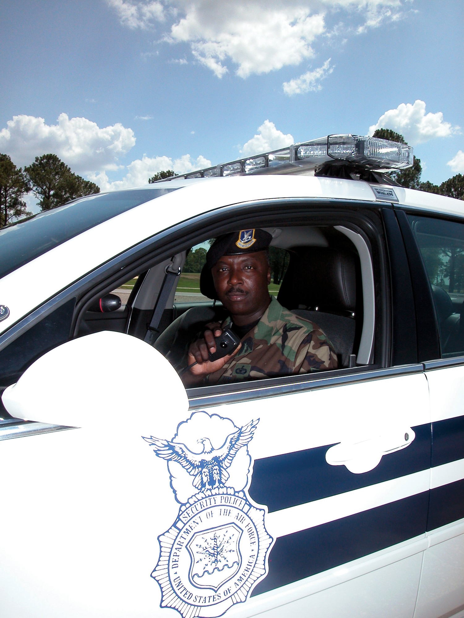 908th Security Force's Squadron's Staff Sgt. Richard Peterson answers a call on his patrol car radio. A member of the Maxwell AFB, Ala.-based 908th Airlift Wing Air Force Reserve unit, Sergeant Peterson is a highly decorated civilian law enforcement officer who is one of the State of Alabama's top police investigators. The Air Force Reservist's role in assisting the Rochester, N.Y., Police Department solve several nearly 10-year-old schoolgirl rape cases was acknowledged in an Arts & Entertainment network's TV series "Cold Case Files" segment that first aired in April 2006.  (U.S. Air Force Photo by Lt. Col. Jerry Lobb)