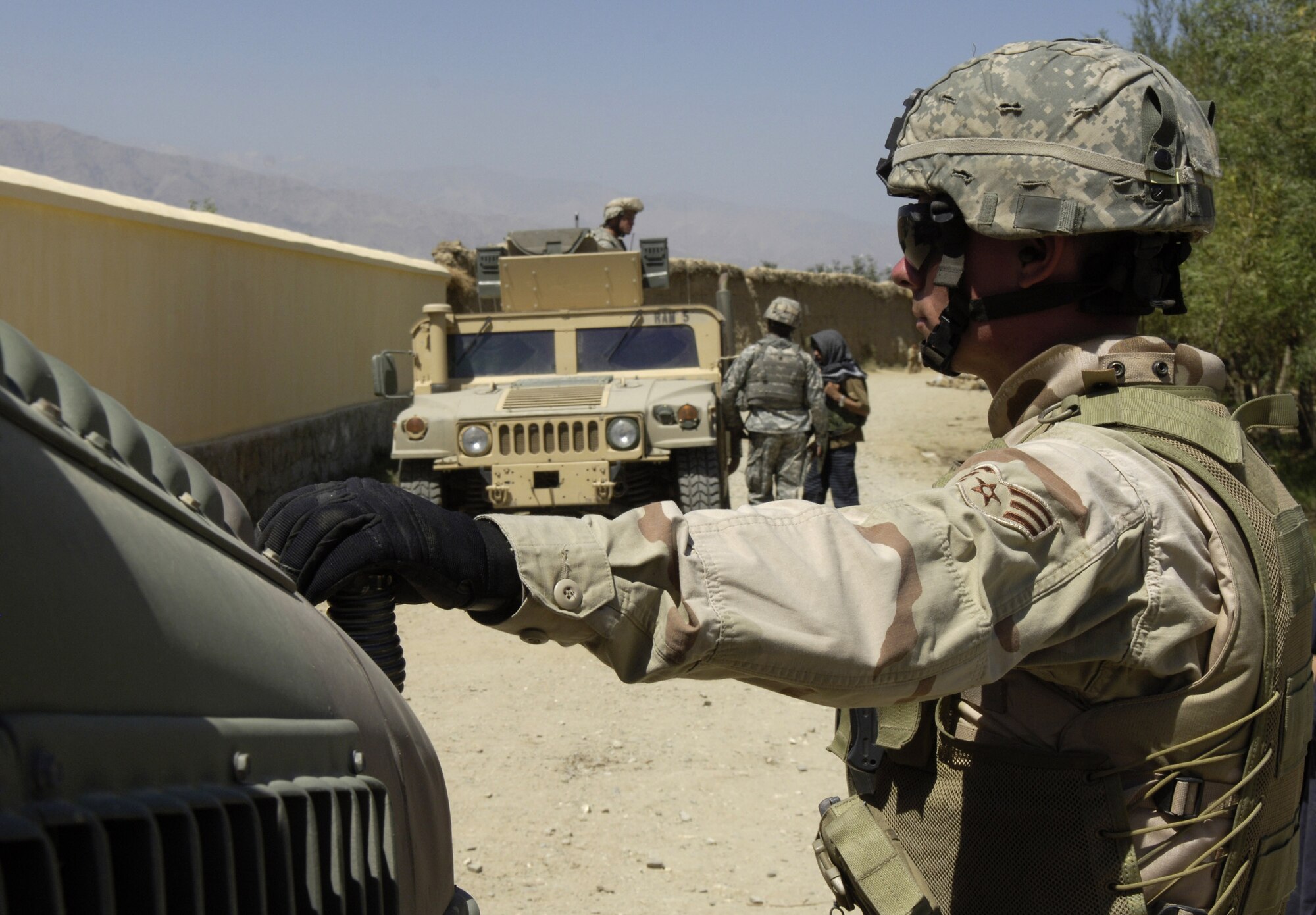 Senior Airman Brandon Eakins pulls security for the Bagram Provincial Reconstruction Team in Afghanistan Aug. 30. The team visited the Aziz-R-Rahman Boys and Girls Primary School to meet with the contractors and discuss deadlines. The mission of the PRT is to extend the authority of the Afghan central government, improve security and promote reconstruction. Airman Eakins is a computer technician with the team and is deployed from Altus Air Force Base, Okla. (U.S. Air Force photo/Senior Airman Brian Ferguson) 
