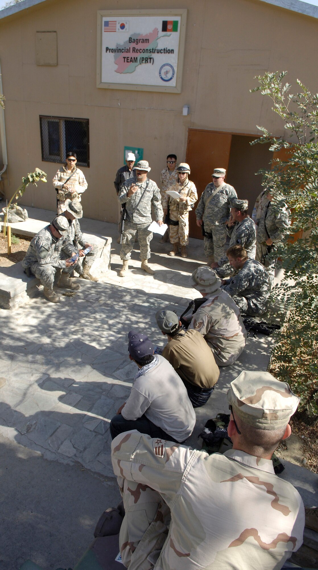 Members of the Bagram Provincial Reconstruction Team and the 102nd Infantry Battalion review convoy security procedures before departing for the Parwan province in Afghanistan Aug. 30. The mission of the PRT is to extend the authority of the Afghan central government, improve security and promote reconstruction. (U.S. Air Force photo/Senior Airman Brian Ferguson)