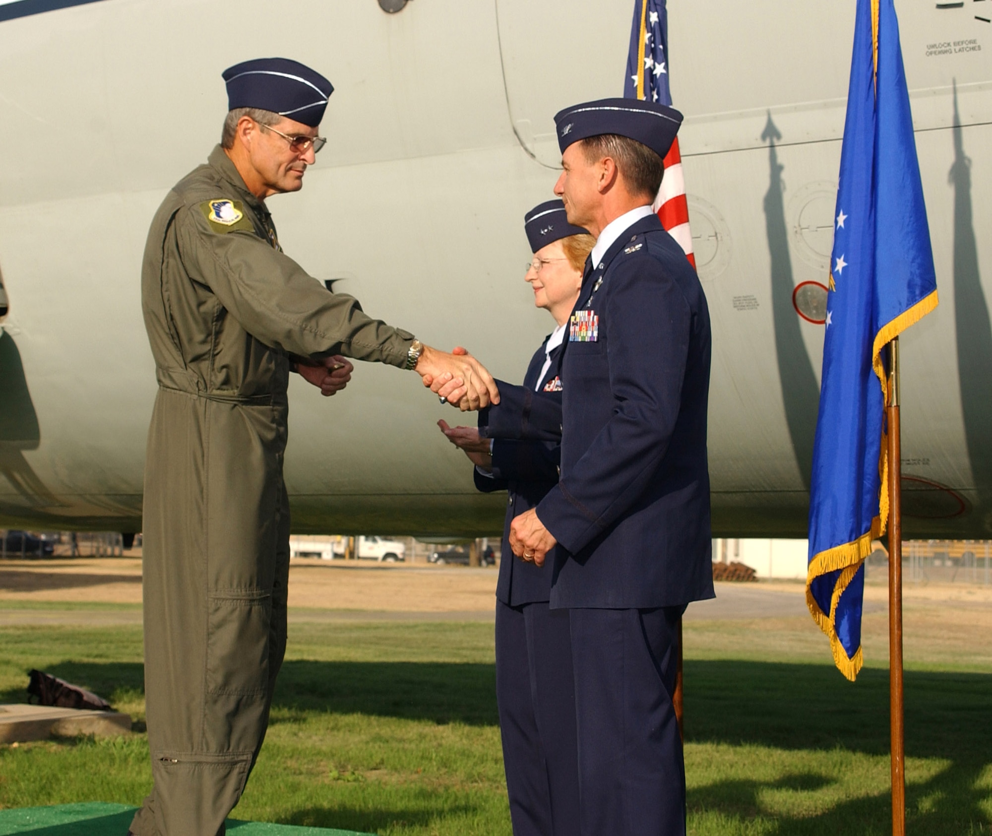 Brig. Gen. David Young, 59th Medical Wing commander, presents wing coins to Maj. Gen. Melissa Rank, assistant Air Force surgeon general for medical force development and nursing services, and Col. (Dr.) Byron Hepburn, command surgeon for Headquarters Air Mobility Command, during the C-9 dedication ceremony at Lackland Air Force Base, Texas, Aug. 31. (U.S. Air Force photo/Master Sgt. Kimberly Yearyean-Siers)
 
