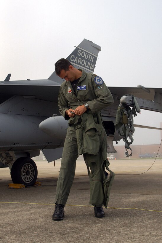 A pilot straps on his flight gear in preparation for takeoff from McEntire Air National Guard Base, S.C., Aug. 28. Airmen from the 169th Fighter Wing are filling an air expeditionary force role for Pacific Air Forces. (U.S. Air Force photo/Tech. Sgt. Carol Smith)     