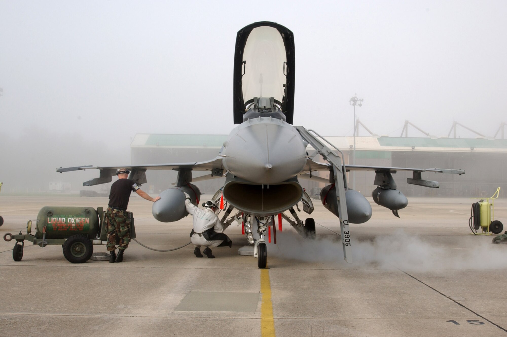 Tech. Sgt. Jason Pry (left) and Senior Airman Justin Butler fill the liquid oxygen tank on an F-16 Fighting Falcon in preparation for takeoff from McEntire Air National Guard Base, S.C., Aug. 28. Members of the 169th Fighter Wing are filling an air expeditionary force role for Pacific Air Forces. The Airmen are assigned to the 169th Maintenance Squadron. (U.S. Air Force photo/Tech. Sgt. Carol Smith)
