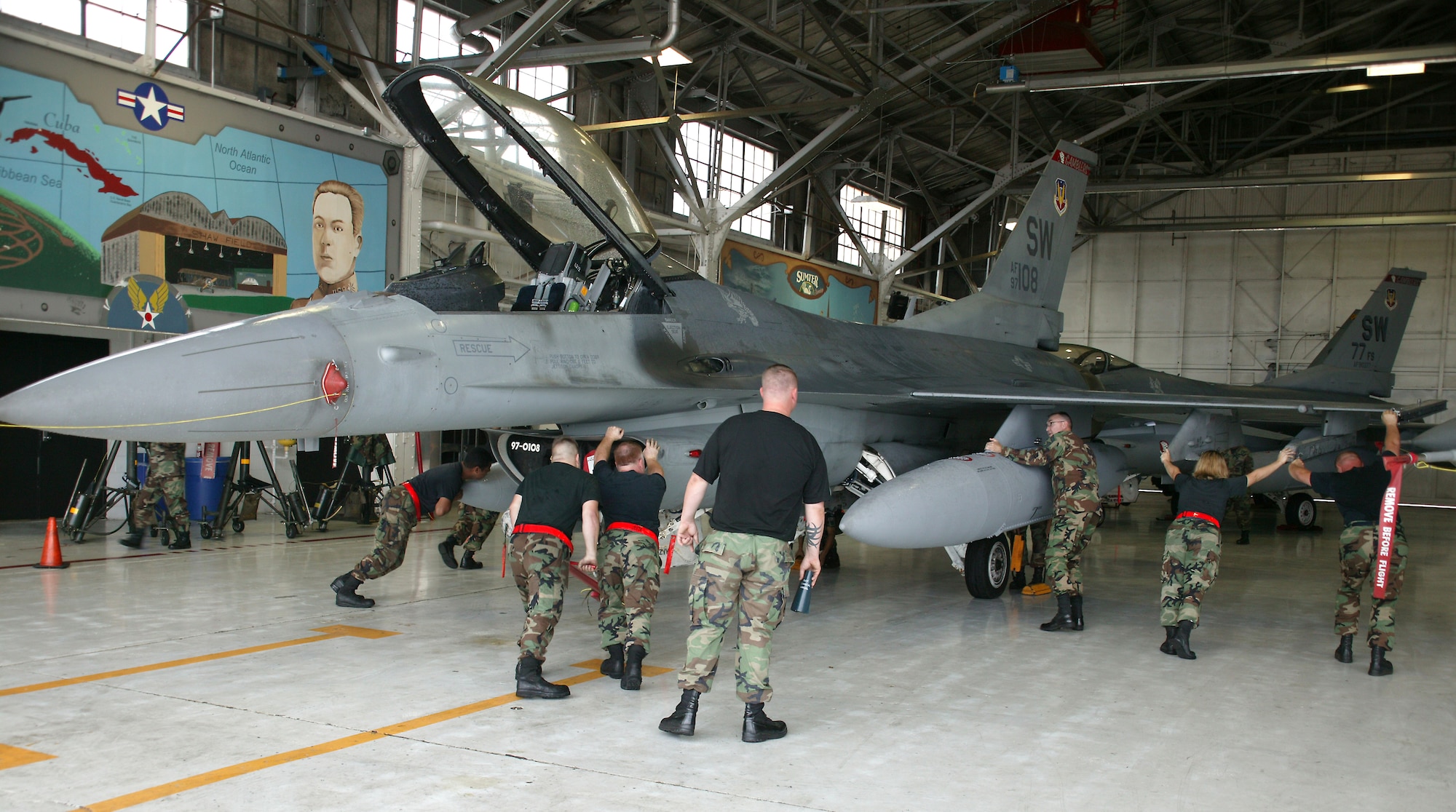 SHAW AIR FORCE BASE, S.C.-- Shaw maintainers push thier F-16 aircraft into the hangar in preparation of Tropical Storm Ernesto. The multiple aircraft were packed into the hangar with hardly any room to spare. (U.S. Air Force photo/Senior Airman John Gordinier)