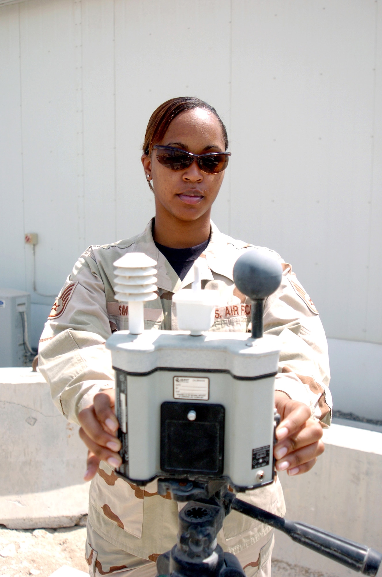 Staff Sgt. Jamica Smith checks the wet bulb globe temperature with a heat stress monitor. The information from the monitor is used to determine the amount of safe physical activity and required water intake in the desert environment. Sergeant Smith is a weather forecaster from the 380th Expeditionary Operations Support Squadron in Southwest Asia. (U.S. Air Force photo/Master Sgt. Stan Coleman)