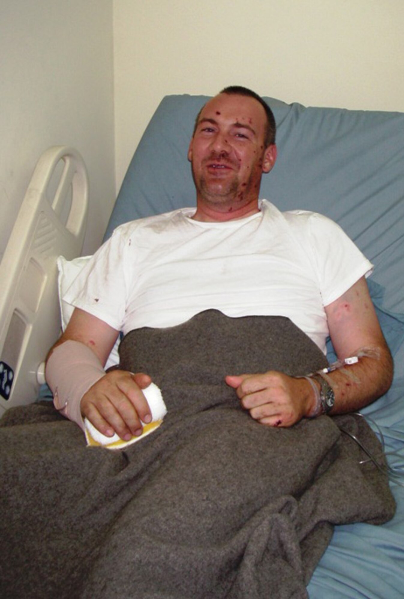 DOVER AIR FORCE BASE, Del. -- Master Sgt. Jeremy Henner, 436th Civil Engineer Squadron explosive ordnance disposal flight chief from Dover Air Force Base, Del., sits in a hospital bed in Baghdad, Iraq, one day after he was injured in an explosion. He was awarded a Purple Heart Aug. 24. (U.S. Air Force courtesy photo)