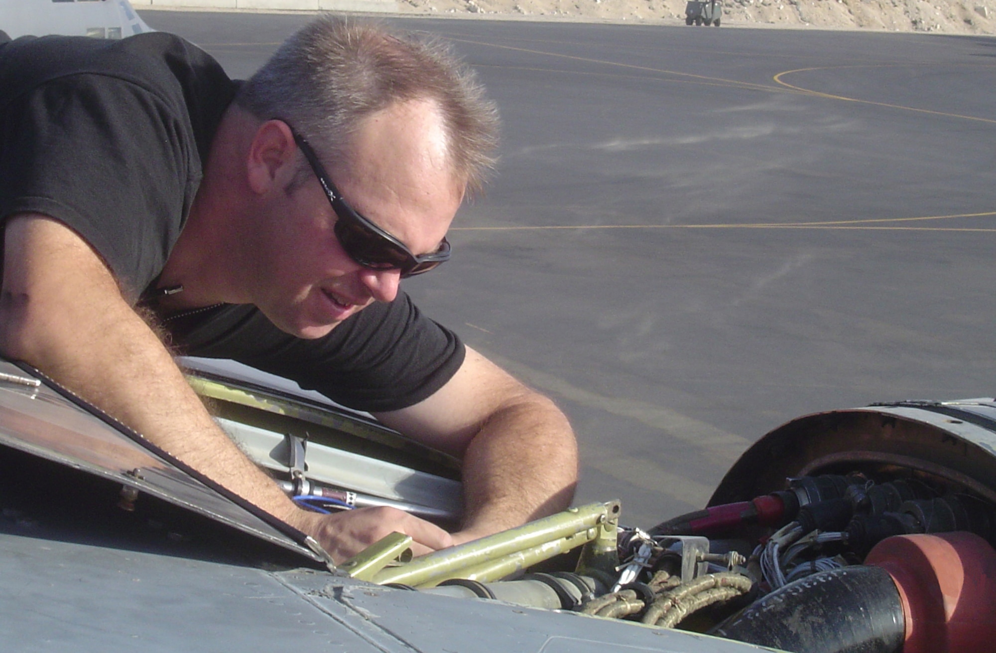 An Airman from the 716th Maintenance Squadron, housed at Eglin Air Force Base, makes repairs to an engine while at a deployed location. The 716th MXS provided maintenance to aircraft belonging to the 8th Special Operations Squadron. (Courtesy Photograph)