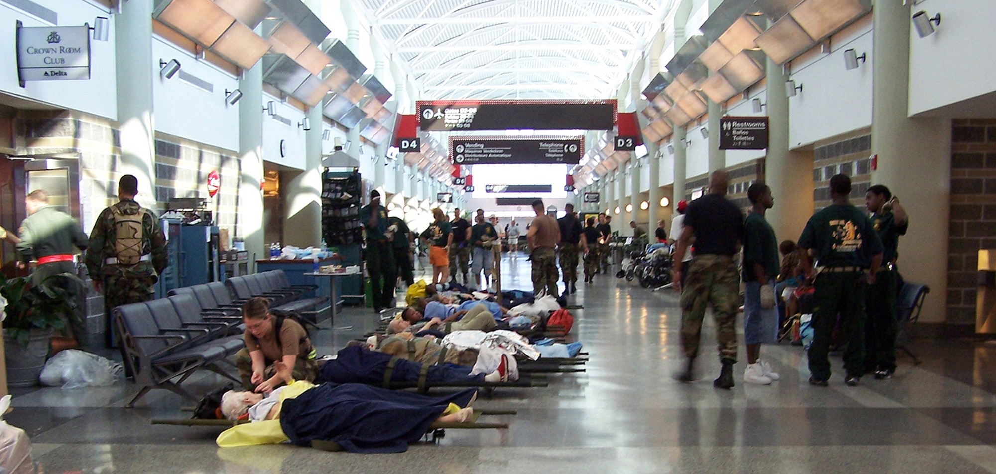 An Air Force medical technician attends to elderly patients on litters on Concourse D in the airport terminal waiting to be evacuated on an Air Force Reserve C-141 from Wright-Patterson AFB, Ohio to Nashville, Tenn.  (U.S. Air Force photo by Maj. Ted Theopolos).