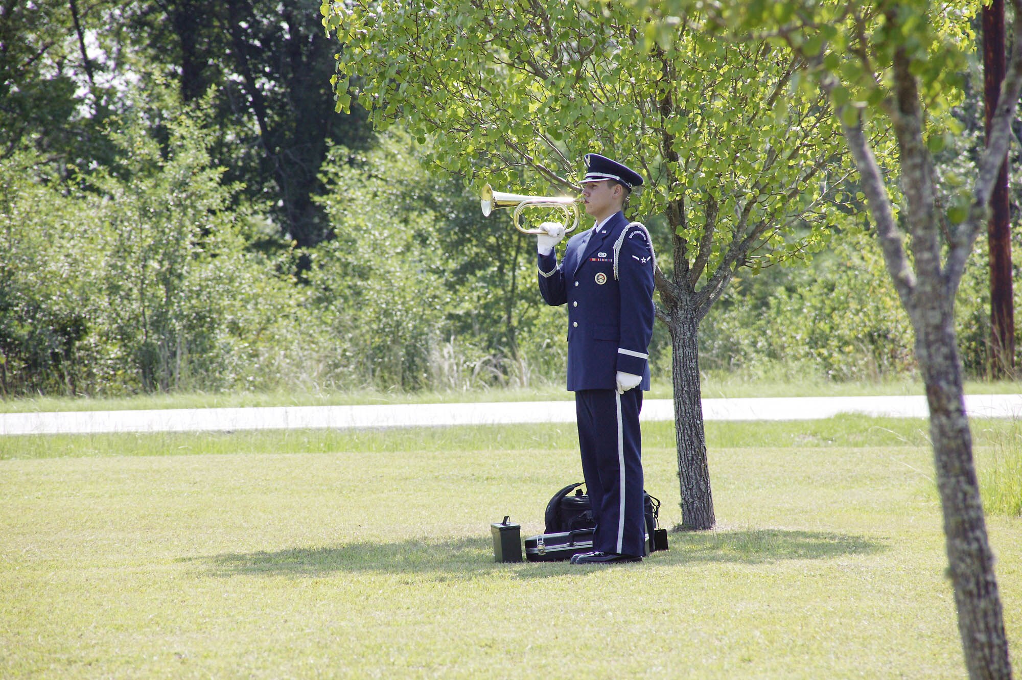 Airman William Iglesias, Shaw Honor Guard member, plays Taps during a retired servicemember’s funeral service.  (U.S. Air Force photo/Senior Airman Holly MacDonald)