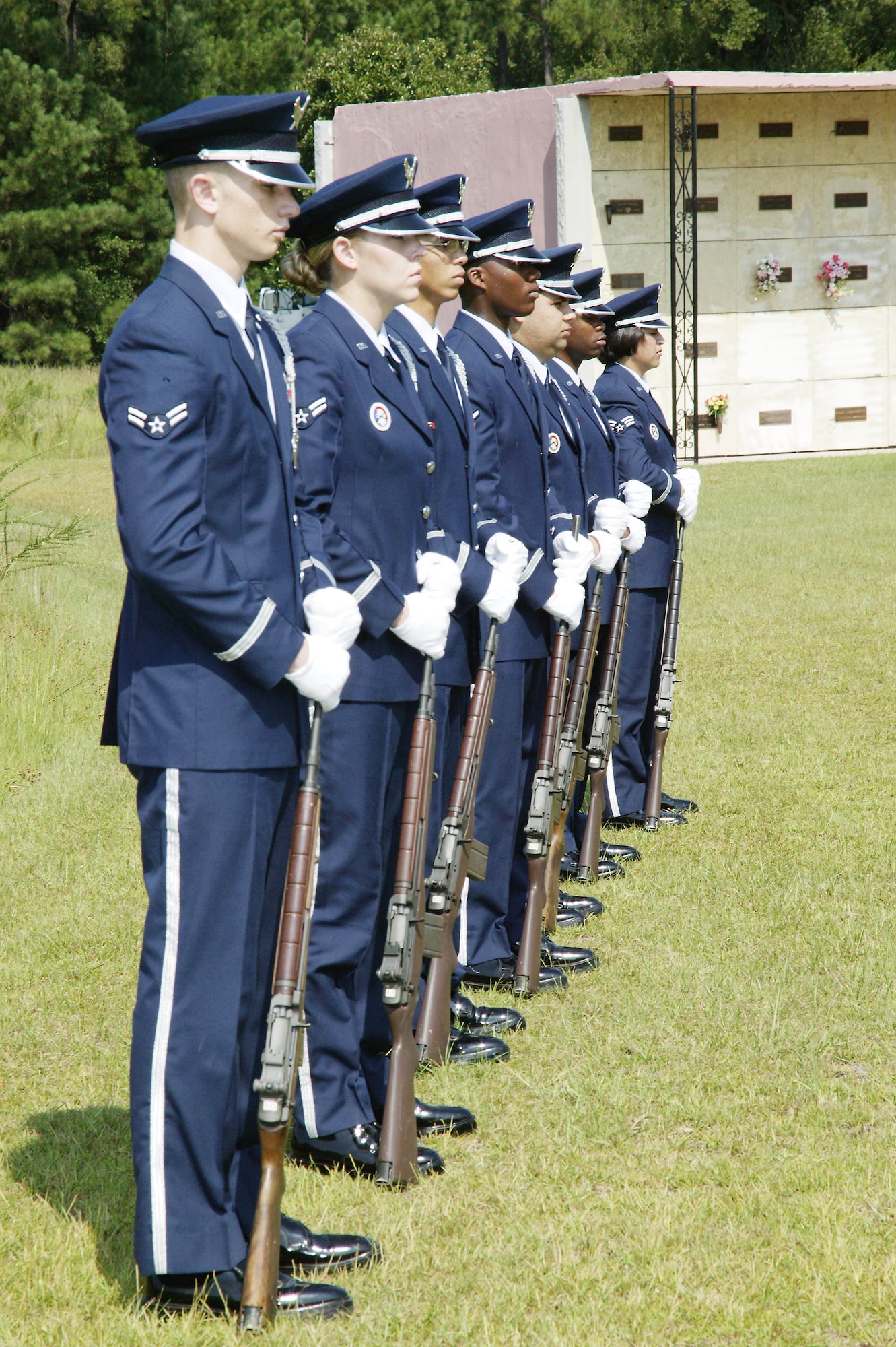 The detail stands at ceremonial at ease during the service, waiting to perform a 21-gun salute in honor of the deceased sevicemember.  (U.S. Air Force photo/Senior Airman Holly MacDonald)