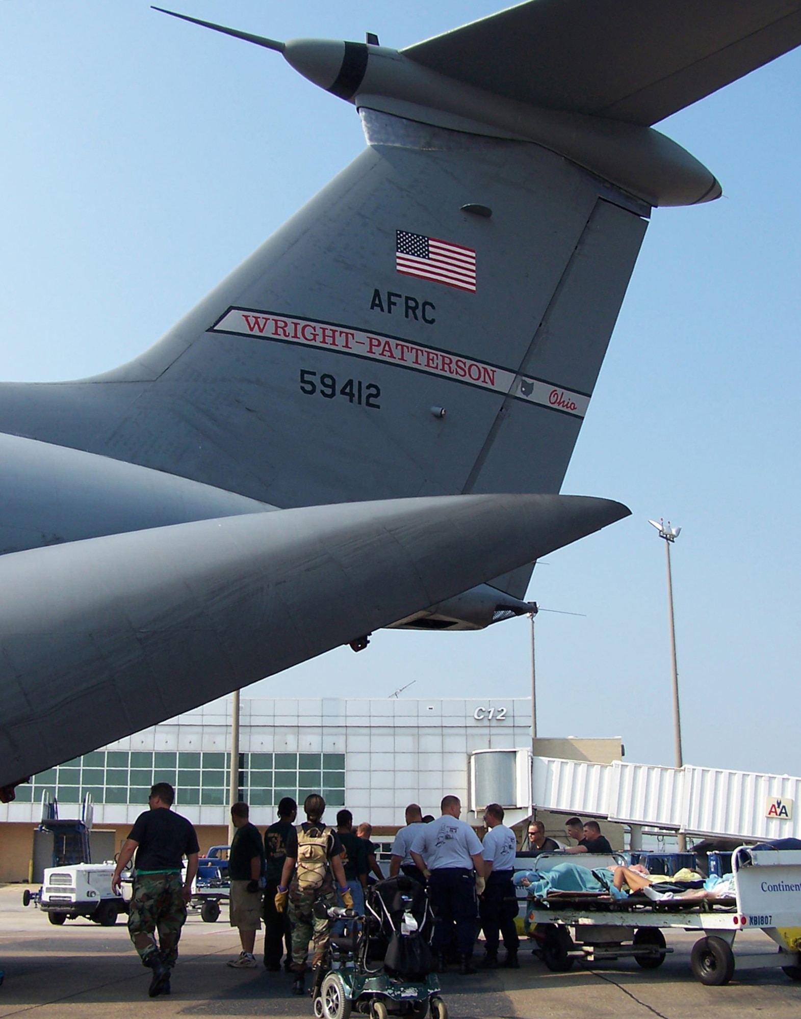 Patients were loaded on a Air Force Reserve C-141 from Wright-Patterson AFB, Ohio to be evacuated to safety.  Medical crews were innovated in transporting litter patients from Concourse D in the airport terminal to the aircraft on luggage carts. (U.S. Air Force Photo by Maj. Ted Theopolos)