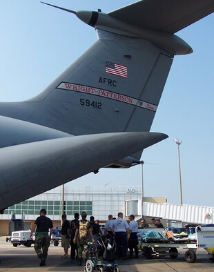 Patients were loaded on a Air Force Reserve C-141 from Wright-Patterson AFB, Ohio to be evacuated to safety.  Medical crews were innovated in transporting litter patients from Concourse D in the airport terminal to the aircraft on luggage carts. (U.S. Air Force Photo by Maj. Ted Theopolos)