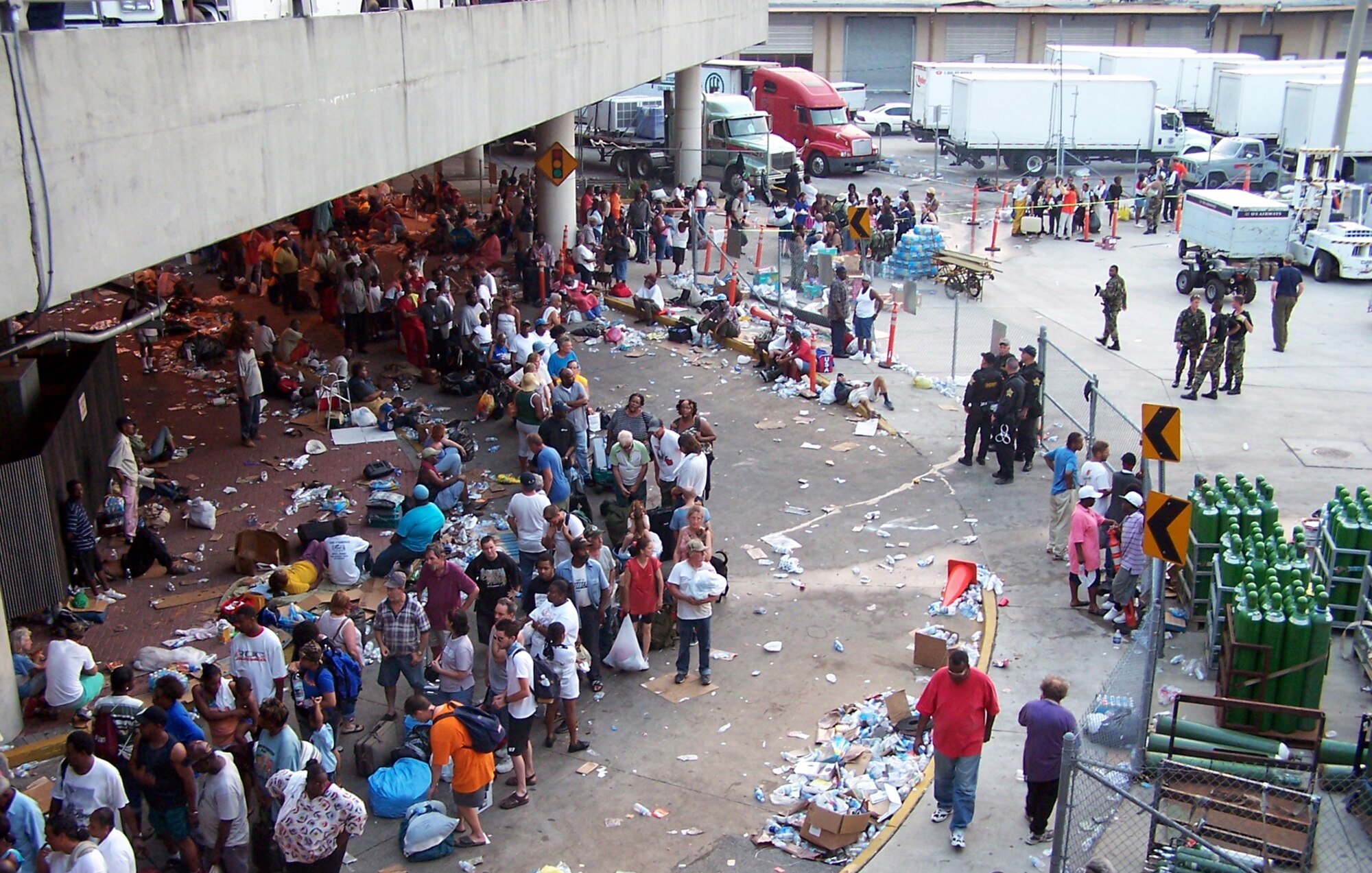 Approximately one year ago residents of New Orleans lined outside the airport seeking to leave the weather torn area.  (U.S. Air Force photo by Maj. Ted Theopolos).