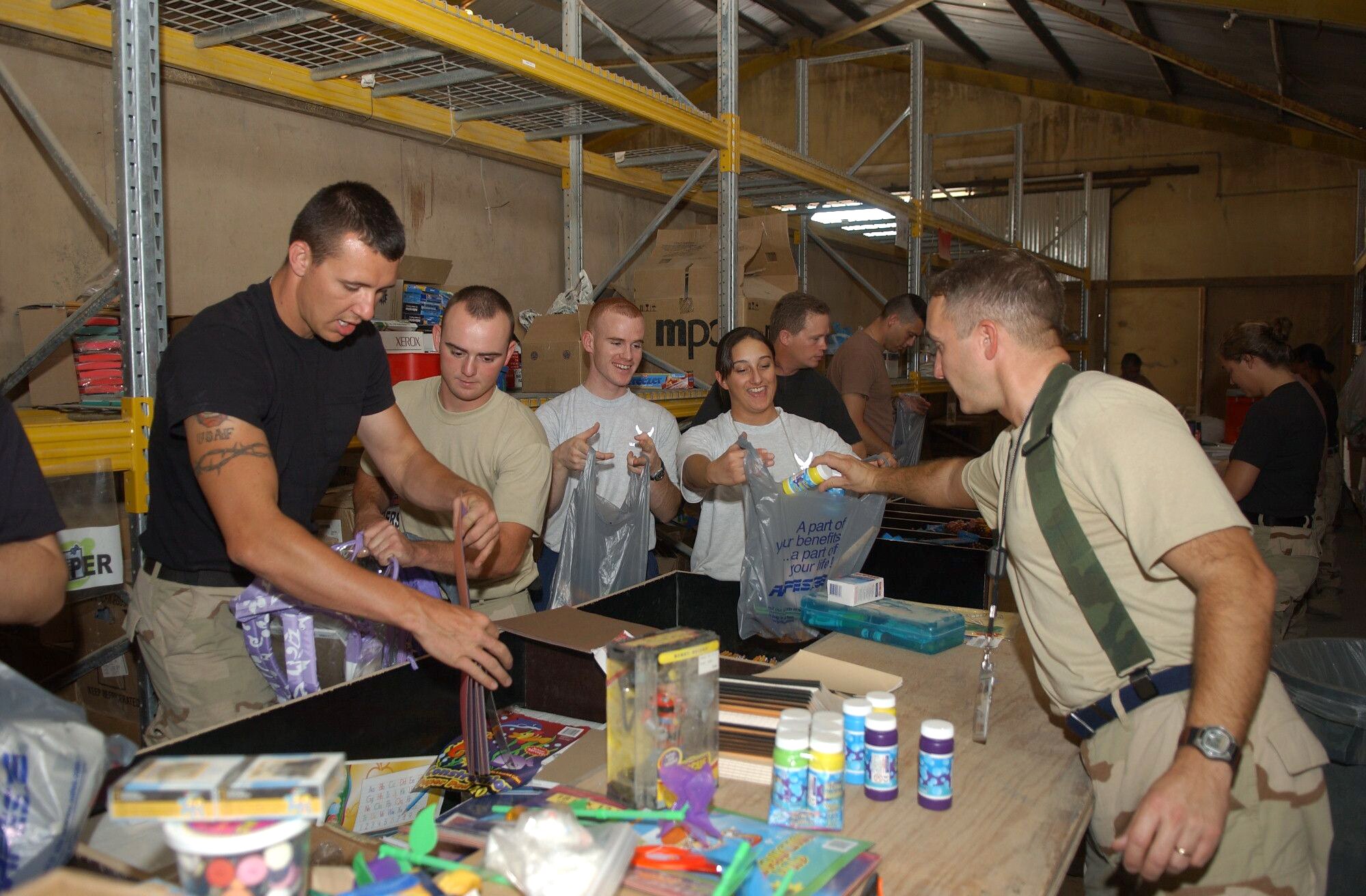 Airmen at Kirkuk Air Base, Iraq, assemble school supply packets with pencils, markers, paper, toys and more.  More than 65 volunteers assembled about 9,000 school supply packets for delivery to local schools.  (U.S. Air Force photo/Senior Airman Angelita Collins)            