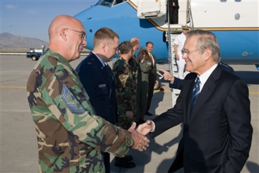U.S. Air Force Chief Master Sgt. Allen E. Chapman welcomes Secretary of Defense Donald H. Rumsfeld to the Utah Air National Guard base in Salt Lake City, Utah, on Aug. 29, 2006.  Rumsfeld is in Salt Lake to speak at the 88th American Legion national convention.  Chapman is attached to the151st Air Reserve Wing.  