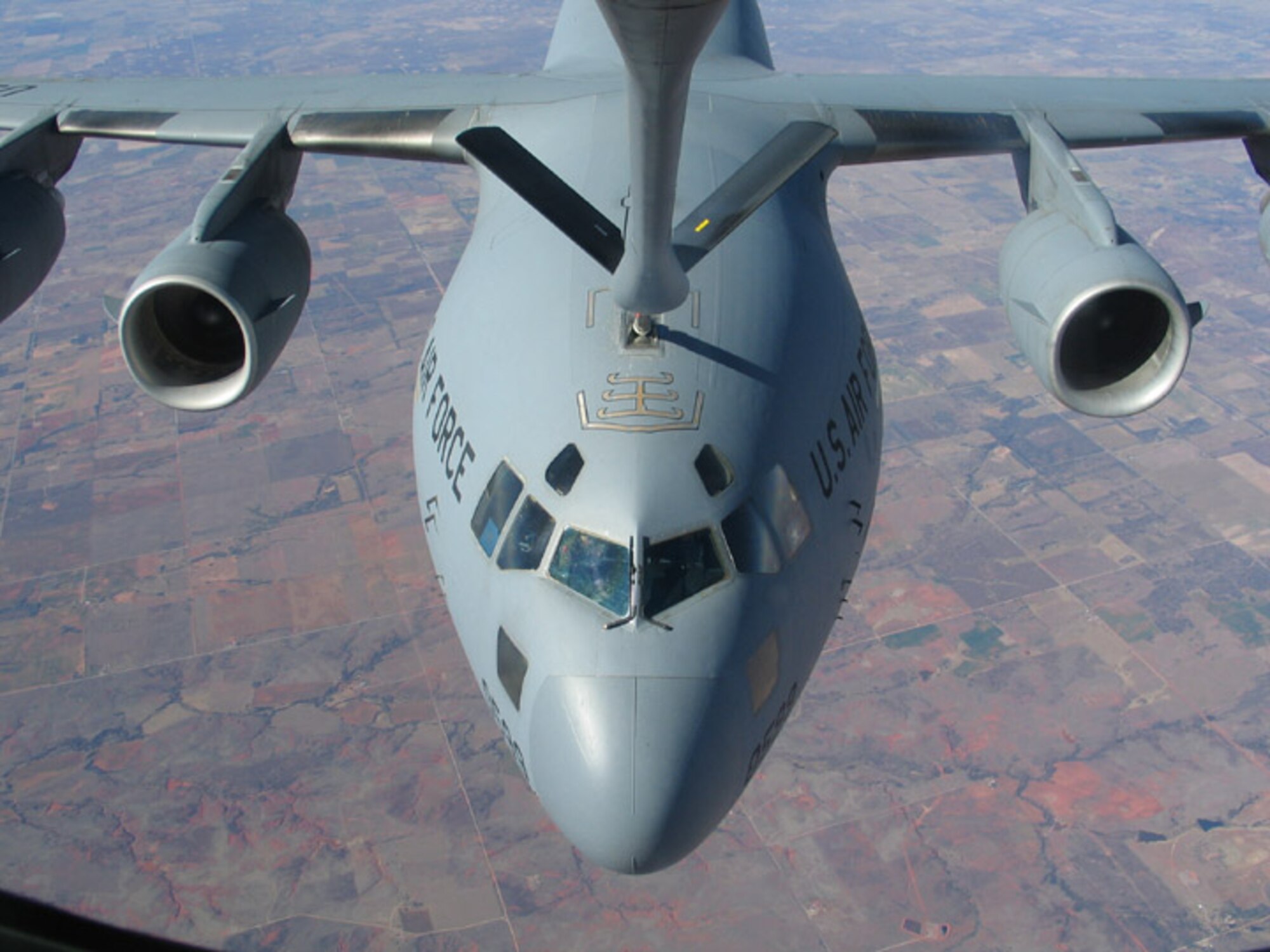 An Altus KC-135 refuels a C-17 from the 58th Airlift Squadron during the Farm City Week familiarization flight Nov. 17.  Every year, the base hosts a number of farmers and other agri-business leaders from the local community on refueling flights to give them an opportunity to learn more about the mission of the 97th Air Mobility Wing.   This year the wing hosted 120 community leaders on two flights.  Earlier in the month the Altus Chamber of Commerce hosted a luncheon and farm tours for members of the base.  The tour included visits to a cotton farming operation and gin, and  a peanut warehouse.  (U.S. Air Force photo/Sharon Fletcher)