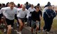 Turkey Trot participants take off by the Lighter-than-Air pool for the 5K race held by the 1st Services Squadron Nov. 22. The winners for the men and women categories are as follows: Men – Kyle Covell (34-under), John Vanderhoven (35-49), Berg Gleis (50-over); women – Jenna Beaty (34-under), Bobbie Skidmore (35-49) and Shirley Stevens (50-over). (Photo by Airman 1st Class Scott Aldridge)
