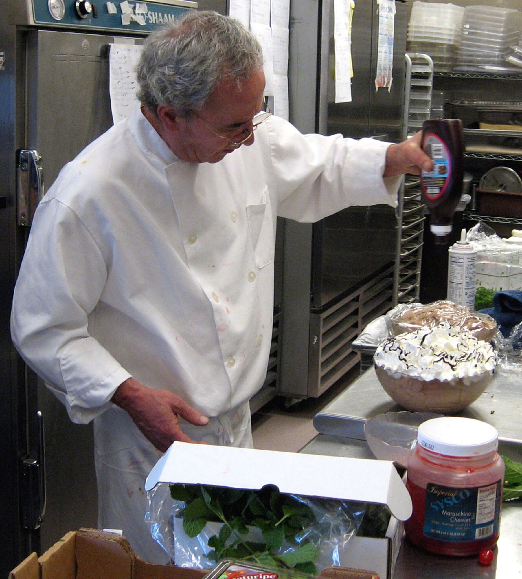 Cook Rino Lacererza drizzles chocolate syrup on a dessert for the Thanksgiving Buffet at the Officers' Club in Minneapolis (U.S. Air Force photo/Margo Leslie)