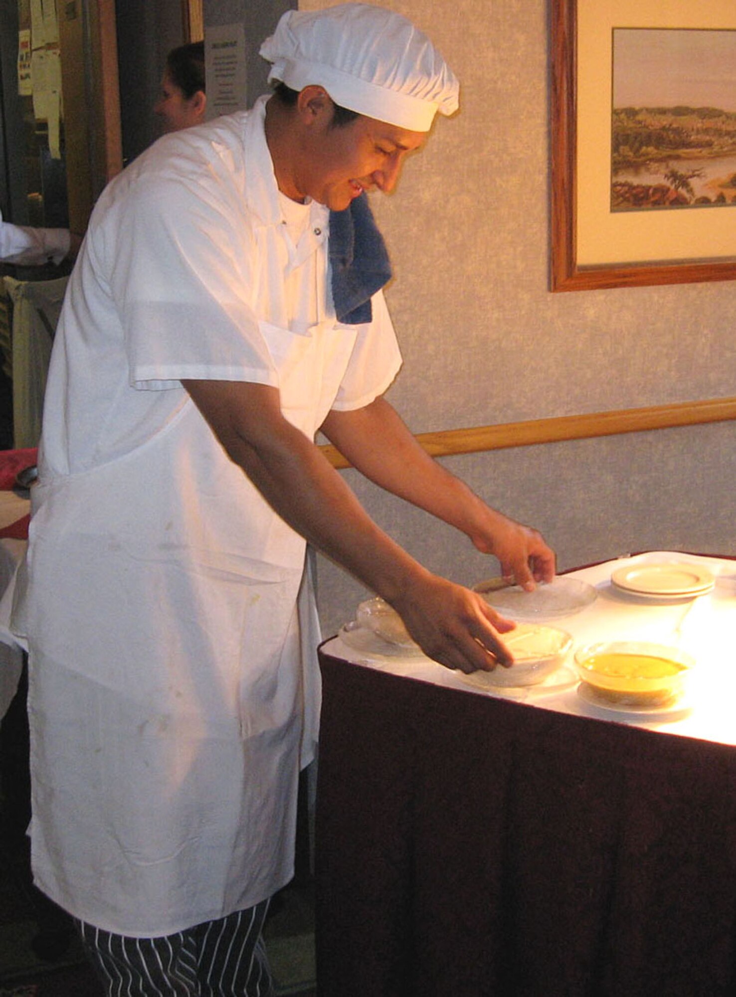 Cook Hector Escobar places condiments on a table in preparation for the Thanksgiving Buffet at the Officers' Club in Minneapolis (U.S. Air Force photo/Margo Leslie)